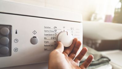 Man preparing the washing machine to start working