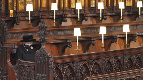 Britain's Queen Elizabeth II looks on as she sits alone in St. Georges Chapel during the funeral of Prince Philip, the man who had been by her side for 73 years, at Windsor Castle, Windsor, England, Saturday April 17, 2021. Prince Philip died April 9 at the age of 99 after 73 years of marriage to Britain's Queen Elizabeth II. (Jonathan Brady/Pool via AP)