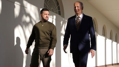 President Joe Biden, right, and Ukraine President Volodymyr Zelenskyy walk down the Colonnade as they make their way to the Oval Office at the White House on December 21 in  2022 in Washington, DC. 