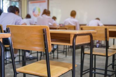 Lecture room or School empty classroom with Student taking exams, writing examination for studying lessons in high school thailand, interior of secondary education, whiteboard. educational concept