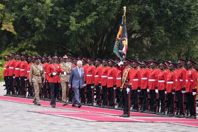 King Charles III, centre, reviews the honor guard during a welcome ceremony at State House, in Nairobi, Kenya Tuesday, October 31, 2023. 