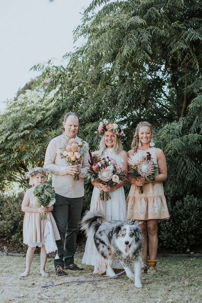 Australian bride and groom surf together before beach wedding