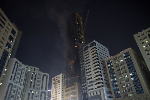 Civil defence forces extinguish a fire that broke out at a high-rise building in Sharjah