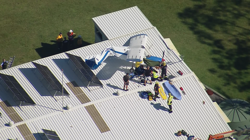 Man injured after light plane crashes on roof of Sydney hangar