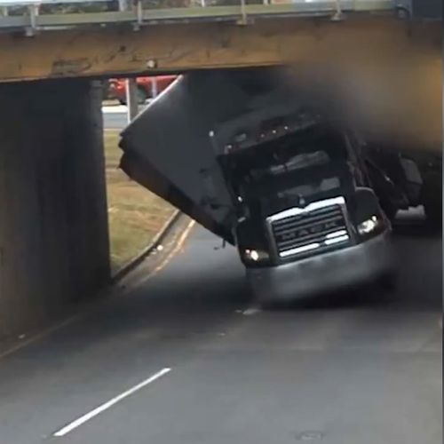 New footage shows truck topple and get jammed under Brisbane bridge