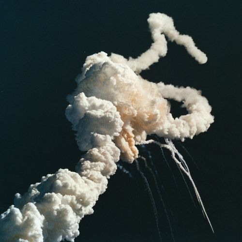 An explosion in the sky as the Space Shuttle Challenger explodes after launch, killing all seven crew members aboard.