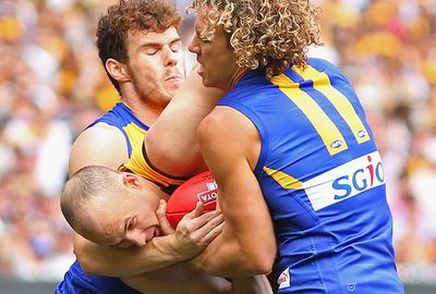 Hawthorn ruckman Hale is wrapped up by Shuey and Priddis.