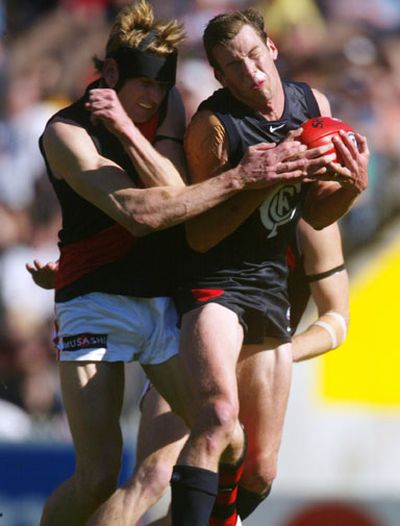 He joined the Bombers in late 1990 but a hip injury prevented his debut in 1991.