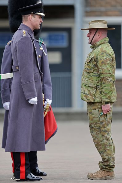 Prince William, Prince of Wales speaks with a member of the 5th Royal Australian Regiment (5RAR) who are currently in the UK helping to train the Ukrainian Armed Forces at Combermere Barracks for the St Davids Day Parade on March 01, 2023 in Windsor, England.  
