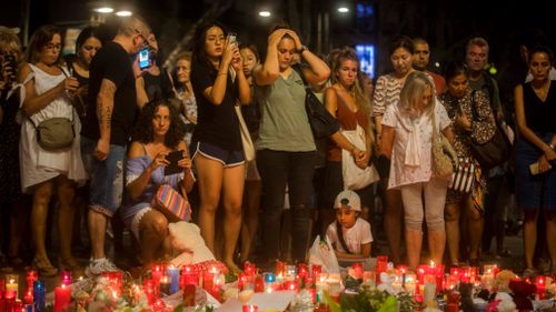 Dozens of mourners have converged at a memorial on Las Ramblas Avenue. (AP)