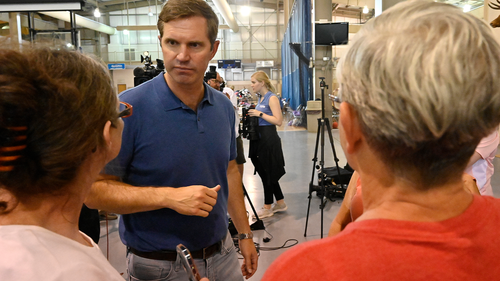 Kentucky Governor Andy Beshear, center, answers question from residents of Knott County Ky., that have been displaced by floodwaters at the Knott County Sportsplex in Leburn,  Sunday, July 31, 2022.