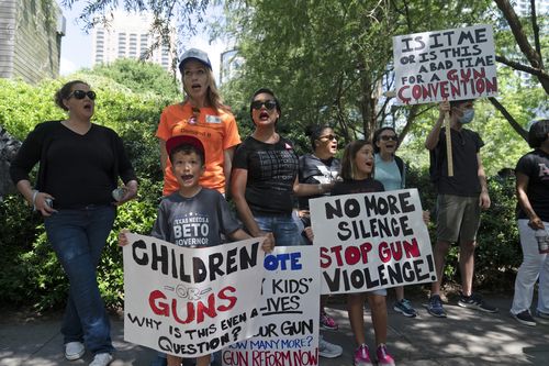 Protesters chant slogans outside the George R. Brown Convention Center to protest the National Rifle Association annual meeting in Houston, Friday, May 27, 2022. (AP Photo/Jae C. Hong)