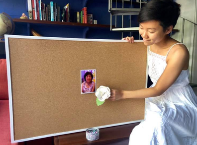 Belinda Teh holding a photo of her mother ahead of her death in 2016.