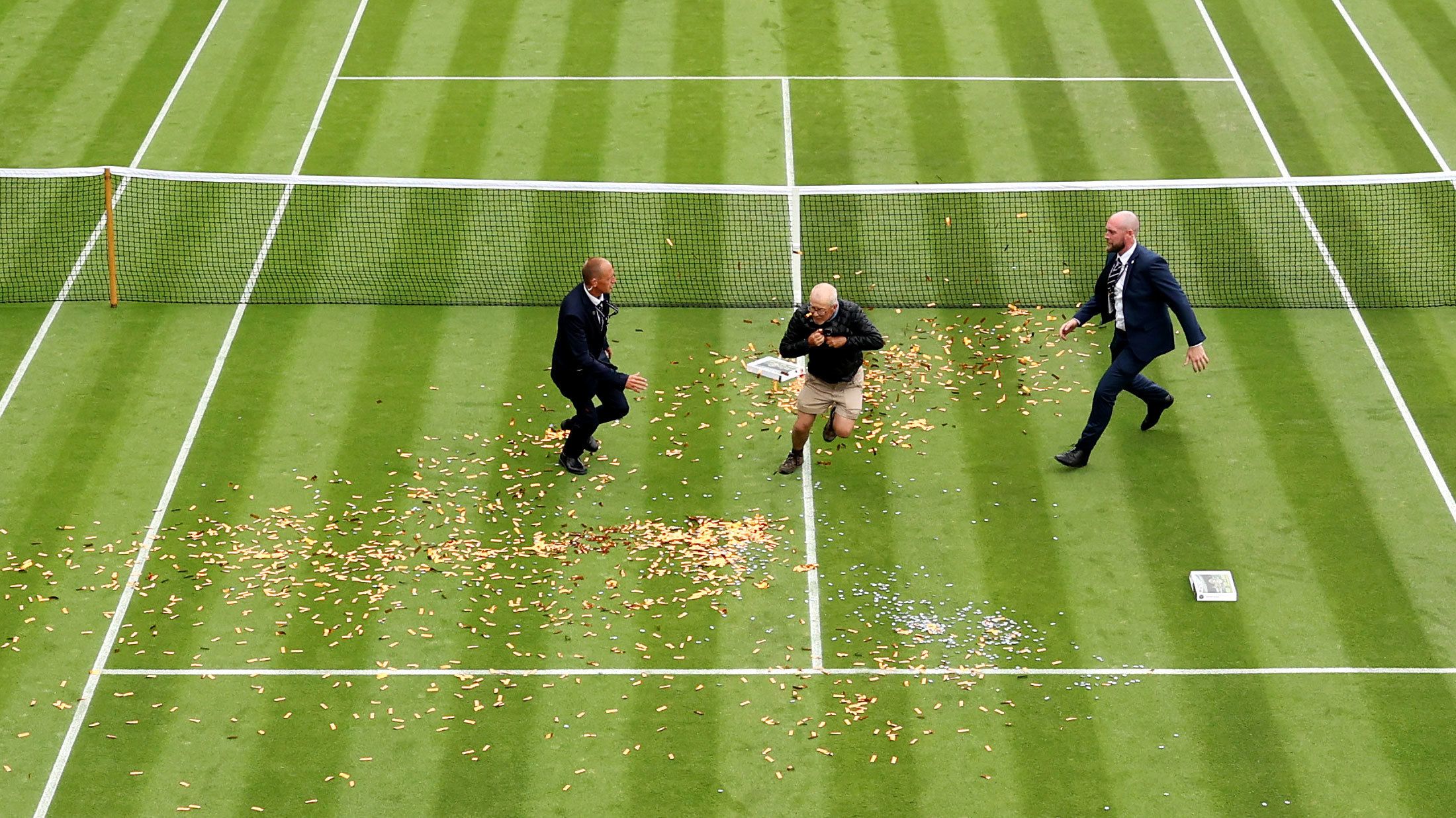 A protester trespasses on to court 18 in a Just Stop Oil protest during the women&#x27;s singles first round match between Katie Boulter and Australia&#x27;s Daria Saville of Australia during day three of The Championships Wimbledon.