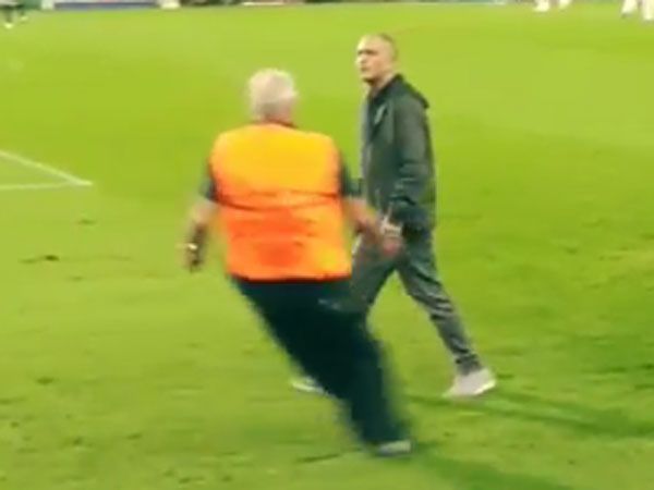 Pitch invader gives football steward the slip
