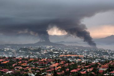Smoke rises during protests in Noumea, New Caledonia, Wednesday May 15, 2024. 