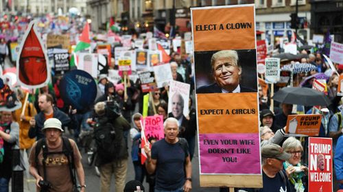 'Even your wife doesn't like you,' one mocking placard reads.