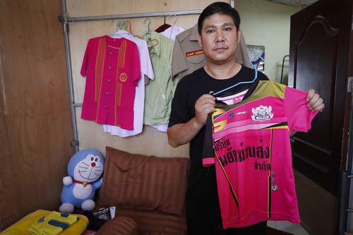 Banphot Konkum, father of Duangpetch Promthep, one of the rescued Thai boys, shows his son's soccer jersey during an interview at their home in Mae Sai district. Picture: AAP