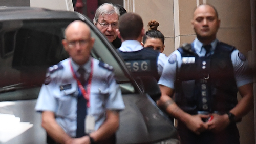 Cardinal George Pell (second from left) arrives at the Supreme Court of Victoria 