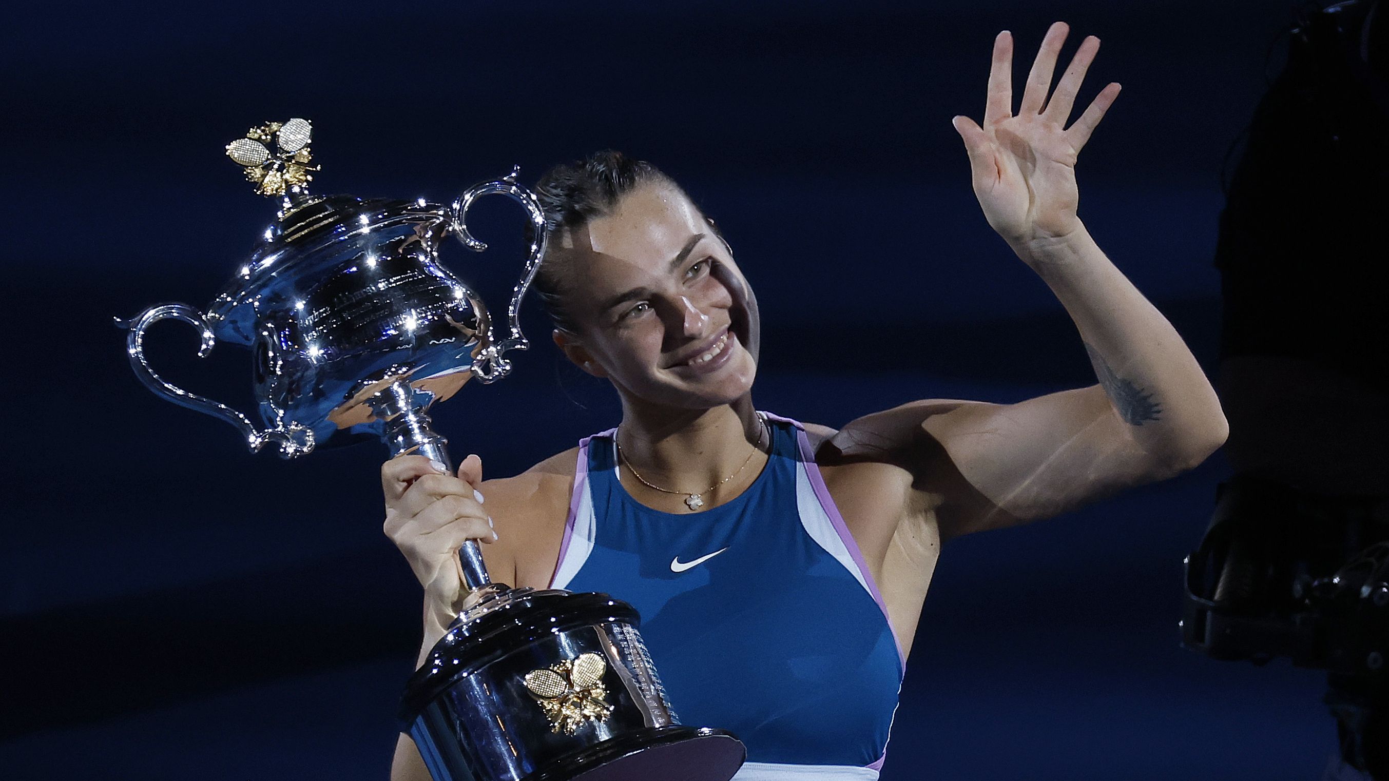 Aryna Sabalenka of Belarus waves as she holds the Daphne Akhurst Memorial Trophy.