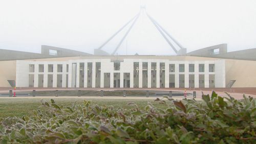 Parliament house in Canberra covered by a frosty mist
