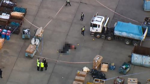Woman struck and killed by garbage truck in car park of Melbourne business