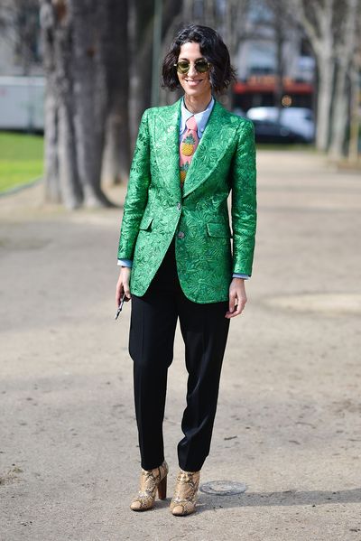 Fashion
peacock Yasmin Sewell combines her emerald green Gucci brocade blazer with a
playful, novelty pineapple tie, slouchy trousers and snakeskin boots