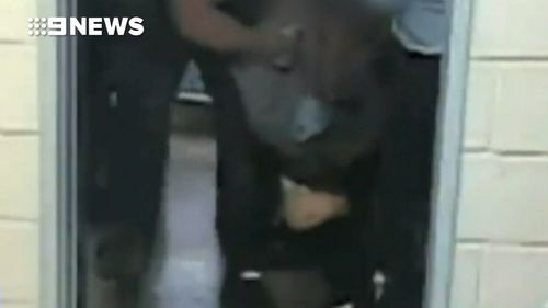 Confronting video showed guards leaning on Morrison as they restrained him.