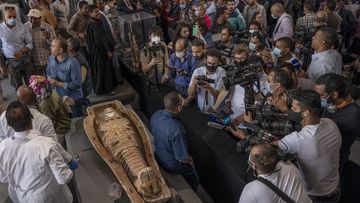 Egyptian antiquities officials on Saturday announced the discovery of at least 100 ancient coffins, some with mummies inside, and around 40 gilded statues south of Cairo.
