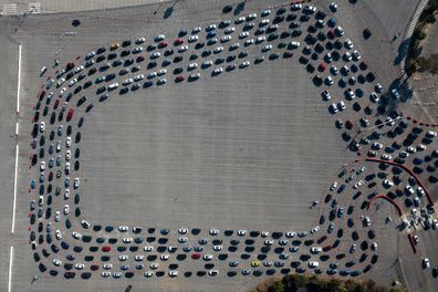 Motorists line up to take a coronavirus test in a parking lot at Dodger Stadium