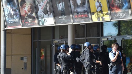 Police forces stand in front of the German cinema (Getty) 