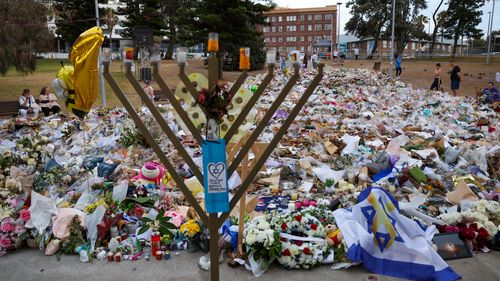 SYDNEY, AUSTRALIA - DECEMBER 21: General view of the memorial at Bondi Pavilion on December 21, 2025 in Sydney, Australia. Life slowly returned to normal at Bondi Beach, with people from all walks of life still paying respects and tributes as raw grief and funerals gave way to quiet commemorations. Police say at least 16 people, including one suspected gunman, were killed and more than 40 others injured when two attackers opened fire near a Hanukkah celebration at the world-famous Bondi Beach, i