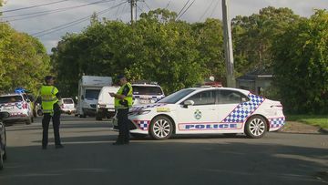 A man is fighting for his life while another is in custody after an alleged stabbing near a Brisbane school. 