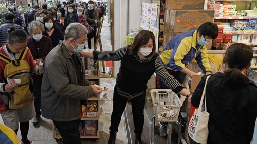 People queue up to buy face masks in Hong Kong, Friday, Feb. 7, 2020