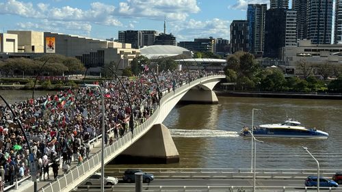 Pro-Palestine protesters march across Brisbane's Victoria Bridge.