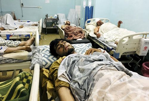 Wounded Afghans lie on a bed at a hospital after a deadly explosions outside the airport in Kabul, Afghanistan, Thursday, Aug. 26, 2021. Two suicide bombers and gunmen attacked crowds of Afghans flocking to Kabul's airport Thursday, transforming a scene of desperation into one of horror in the waning days of an airlift for those fleeing the Taliban takeover. The attacks killed at least 60 Afghans and 12 U.S. troops, Afghan and U.S. officials said. (AP Photo/Mohammad Asif Khan)