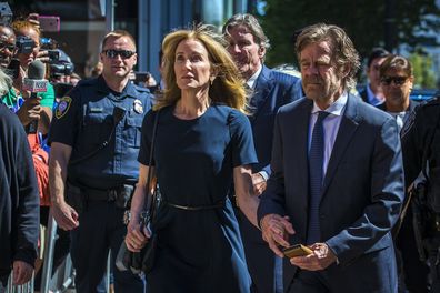 Felicity Huffman arrives with her husband William H. Macy at John Joseph Moakley US Courthouse in Boston on Sept. 13, 2019. She gets 14 days jail for her role in the college admissions scandal