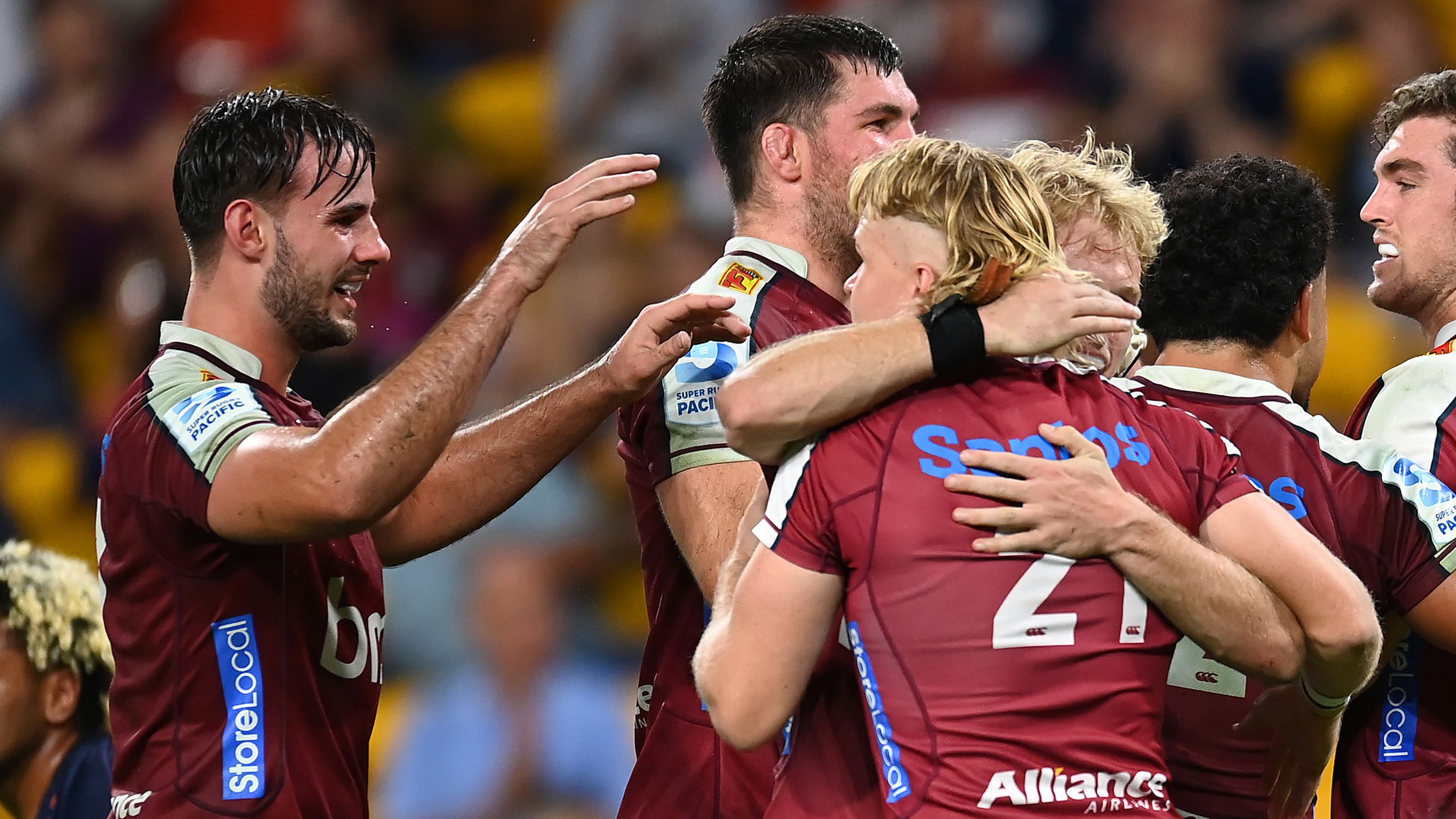 Lawson Creighton of the Reds celebrates with team mates after scoring a try during the round nine Super Rugby Pacific match against the Highlanders.