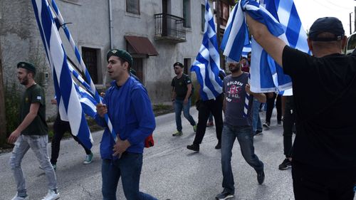 Greek opponents of the deal between Greece and Macedonia on the latter country's new name of North Macedonia hold Greek flags as they protest at the village of Pisoderi. (AP).