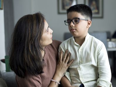 Loving mother spending leisure time with son at home