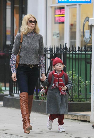 Supermodel Claudia Schiffer doesn't miss a style step with knee-high boots and oversized sunnies, while walking daughter Clementine to school in London, 2011.