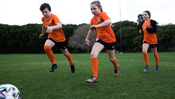 Siblings, Finnair, Elena and Ishbel Collins from the Balmain and District Football Club, having a kick.