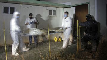A body is carried out of the crematorium in Acapulco, Mexico. (AAP)