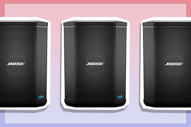9PR: Bose S1 Pro Portable Bluetooth Speaker System without Battery in Black on pink and purple background.