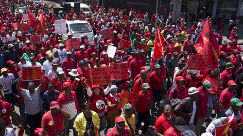 Protesters line the streets in Johannesburg. (AAP)