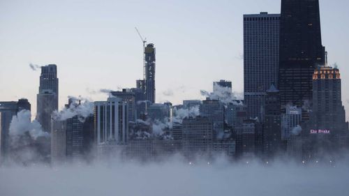 Steam rises over the city of Chicago as the city shivers through -29C temperatures.