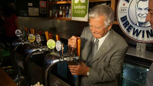 The former PM pours the first ever Hawke's Lager. (9NEWS)