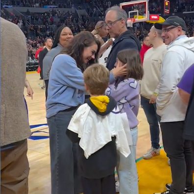 Mila Kunis consoles daughter Wyatt at WNBA game