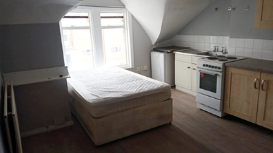 This tiny one-bedroom flat in South London with the bed next to the oven has gone on the market and is asking just under $2k in monthly rent