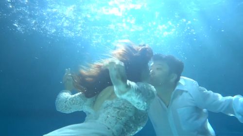 Couples are resorting to taking underwater wedding photos. 